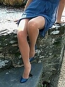 Sexy women in blue heels nude pantyhose and a cheeky blue dress outdoor