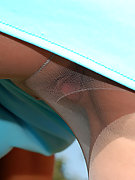 Awesome blonde chick pulling on her flesh-colored pantyhose in weird way